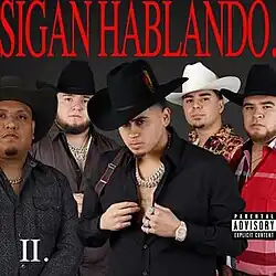 Five men wearing a Tejano hats, neck accessories and cowboy attire. Short-width upper text is read as "Sigan Hablando.", all uppercase, while the text "II." is read on the bottom-left corner and a Parental Advisory logo is seen on the right.