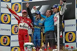2005 photo of [[Michael Schumacher]] and others in tobacco-branded uniforms