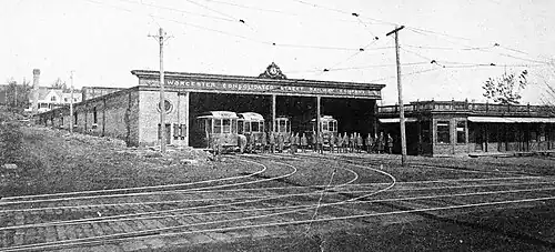 Streetcars in a single-story carhouse