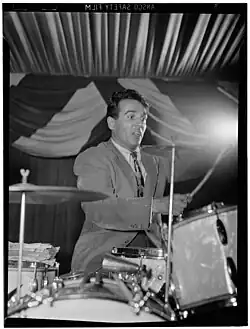 Gene Krupa with two cymbals mounted on a bass drum