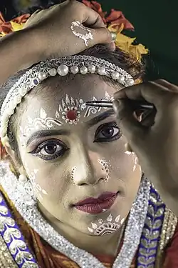 Make-up artist at work before a Gotipua Odissi dance performance