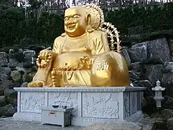 Statue of Budai as Maitreya at Haedong Yonggungsa temple in South Korea