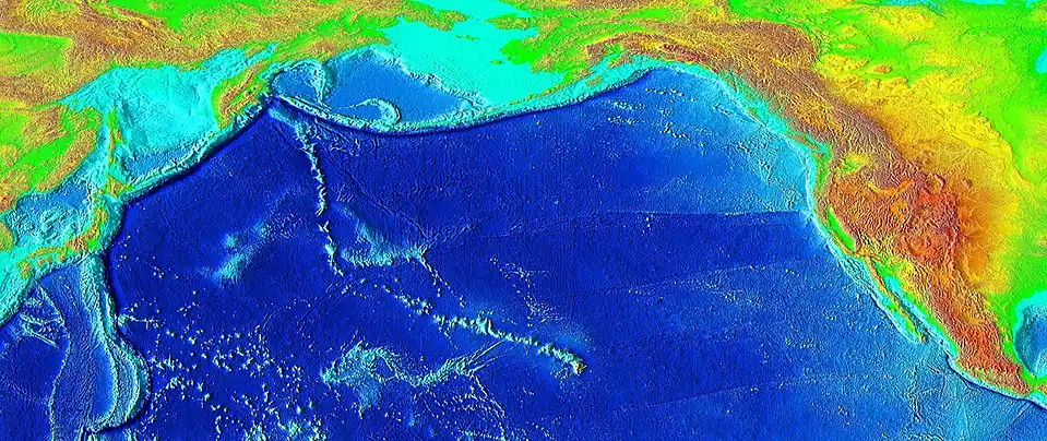 Raised-relief map of the Pacific basin, showing seamounts and islands trailing the Hawai’i hotspot in a long line terminating near the Kamchatka Peninsula in Russia