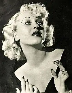 Portrait of a woman with platinum blonde hair and very thin eyebrows