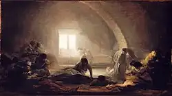 A group of people inside a poorly lit building.