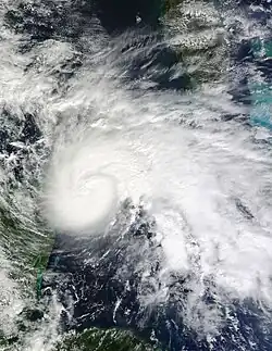 A sprawling hurricane over the Yucatán Channel, with clouds from the storm covering much of the Caribbean
