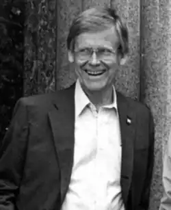 A black and white photo of Ibsen Nelsen wearing a jacket and button up.