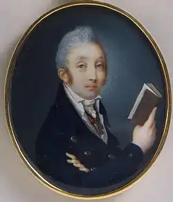 Portrait of a young man with gray hair in a double-breasted, buttoned suit holding a book in his right hand.