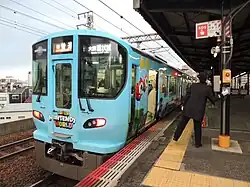 Picture of a 323 series train in Super Nintendo World livery.