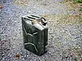 Jerrycan of fuel, WWII. Middle handle for empty can; two outer handles for two people carrying full can.