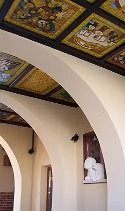 Look up! On the wall there is e limestone sculpture of a boy and his dog who lean out the painted window (painted background on printed foil)