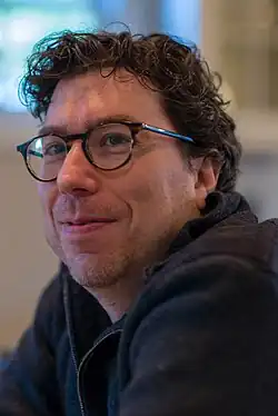 Jonathan Zittrain seated next to a lectern