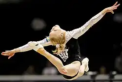 Jonna Adlerteg performing a switch ring leap on the floor exercise