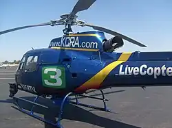 alt=A news helicopter painted with the KCRA logo, "LiveCopter 3" on the tail, and the website KCRA.com up top