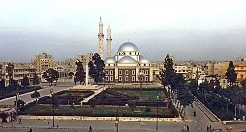 A religious building with multiple silver domes