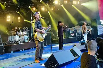 Killing Joke performing at the 2009 Ilosaarirock Festival. From left to right: Ferguson (background), Walker, Coleman, Youth