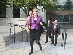 Sinema walking up stairs and smiling to the camera