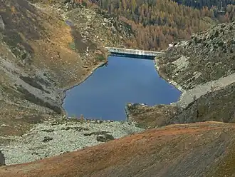 A dammed body of water surrounded by mountains.