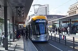 Front of silver and yellow tram