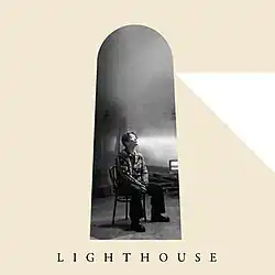 Cover artwork. Gen Hoshino sits on a chair within a shape mimicking a lighthouse.