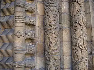 On these mouldings around the portal of Lincoln Cathedral are formal chevron ornament, tongue-poking monsters, vines and figures, and symmetrical motifs.