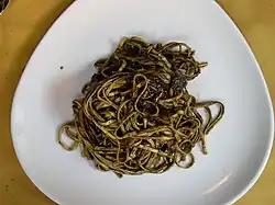 Three-sided white plate containing linguini