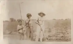 a child and two adults pose with props