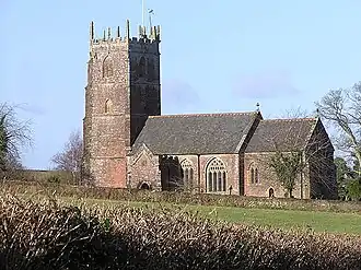 Reddish building with square tower.