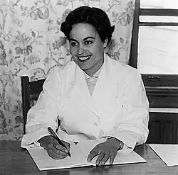 Rina Moore writes in a notebook