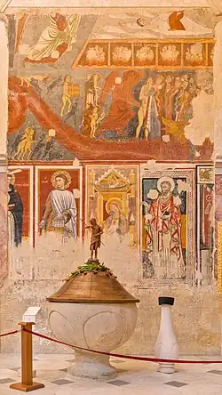 Baptismal fonts and 14-15th-century frescos, one of them depicting the Last Judgment