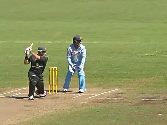 Matthew Hayden smashing Irfan Pathan for another boundary as Dhoni looks on
