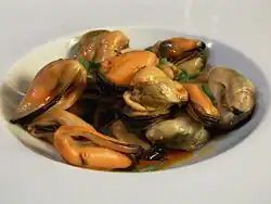 Mejillones en escabeche – pickled mussels preserved in vinegar, oil, and spices.