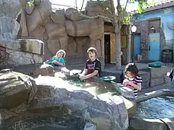 Children in the interactive gold panning exhibit.