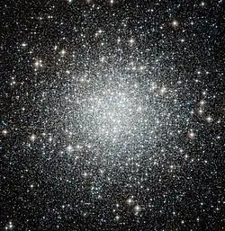 Thousands of white-ish dots scattered on a black background, strongly concentrated towards the center