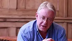 Michael Bywater, British writer and broadcaster, seated and speaking