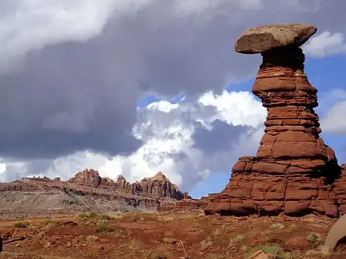 Hoodoo within the Chinle Formation, west of Moab, Utah, along the Hurrah Pass backroad. Ridge in background is part of the Wingate Sandstone.