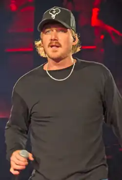 Singer Morgan Wallen, strumming an acoustic guitar