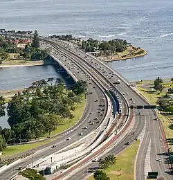 A highway and railway bridge crossing a river viewed from a skyscraper