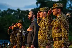A photograph of Nayib Bukele standing alongside military officers