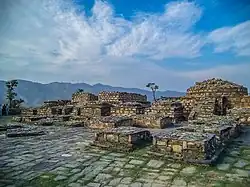 Nemogram Stupa, dating from the Kushan period c. 2-3 centuries CE, with many of its statues on display at the Swat Museum