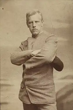 Portrait of a stern and determined looking man with arms crossed.