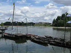 Photograph of futreaux (flat-bottomed Loire boats) and skiffs docked at Orléans