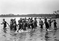 Orphan girls playing in the Tidal Basin in 1924. A float and a diving platform are in the background.