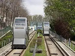 A photograph looking up the railway, showing the two tracks receding into the distance and two cabins, one nearer than the other