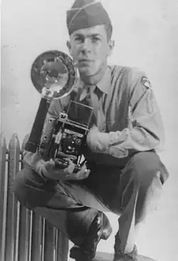 Black-and-white portrait of Averitt holding a camera