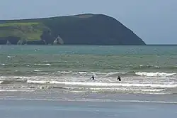 People surfing at a beach in Pembrokeshire
