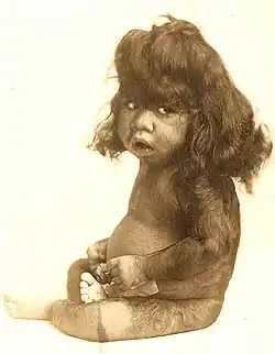 Sepia photograph of Percilla Bejano as a baby - she is covered in naturally long, dark hair all over her head, arms, and legs.