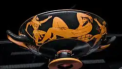Greek cup, painting in red figure: Heracles moves towards a reclining giant.