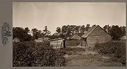 Old black-and-white photo of wooden shacks