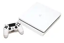 A white PlayStation 4 Slim console and a white DualShock 4 controller
